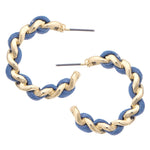 Pair of gold and blue hoop earrings on a white background
