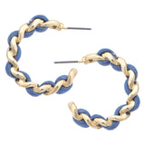 Pair of gold and blue hoop earrings on a white background