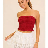 White lace mini skirt with layered lace and a flouncy hem, shown on a model