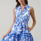 Luna Crest Floral Zady Sleeveless Mini Dress in two colors, floral pattern, collared neck, button front, belted waist, ruffle mini hem, styled with sun hat, mini bag, and flat sandals