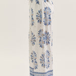White pants with blue floral patterns on a white background
