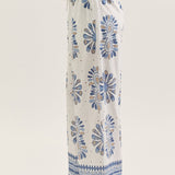 White pants with blue floral patterns on a white background