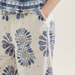 Close-up of a person wearing a blue and white patterned outfit with a focus on the pants.