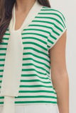 Green and white striped sleeveless top worn by a person