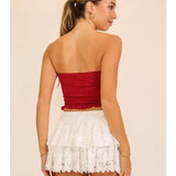 White lace mini skirt with layered lace and a flouncy hem, shown on a model